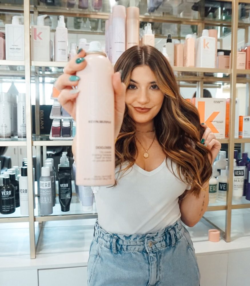 Stylist with retail haircare in the salon